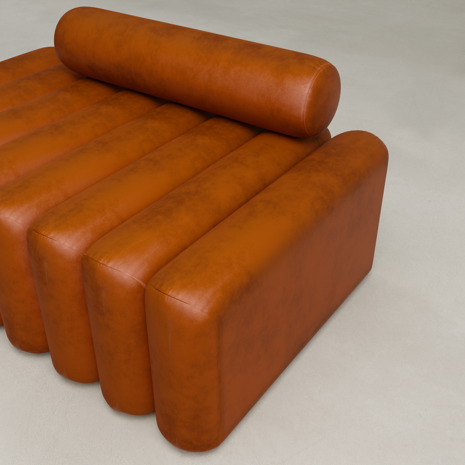 The Sonorra Bench Medium features a modern, orange-brown ribbed leather design with cylindrical backrest and armrest, providing plush seating on a light-colored floor.