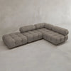 The Belmont Sofa Combination C features marshmallow-like curves, tufted plush cushions, and cylindrical headrests, all upholstered in light gray fabric and displayed against a plain light gray background.