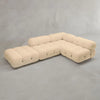 The Belmont Sofa Combination C is a modern, modular sectional with beige tufted fabric and rounded, marshmallow-like cushions, arranged in an L-shape on a plain gray floor against a light gray wall.