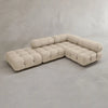 The Belmont Sofa Combination C is a modern, beige L-shaped sectional with tufted upholstery, marshmallow-like curves, and rounded cushioned arm and backrests, displayed against a plain light gray background.