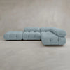 The Belmont Sofa Combination C is a light blue, tufted sectional with marshmallow-like curves, plush cushions, and a modern minimalist modular design featuring three main seating sections set against a plain light beige background.