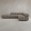 The Belmont Sofa Combination C features a modern, modular design with marshmallow-like curves, rounded tufted cushions, and low backrests, set against a neutral light grey textured wall and floor.