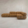 The Belmont Sofa Combination C is a modular brown leather sectional with tufted cushions, marshmallow-like curves, and rounded edges, set against a neutral textured background.