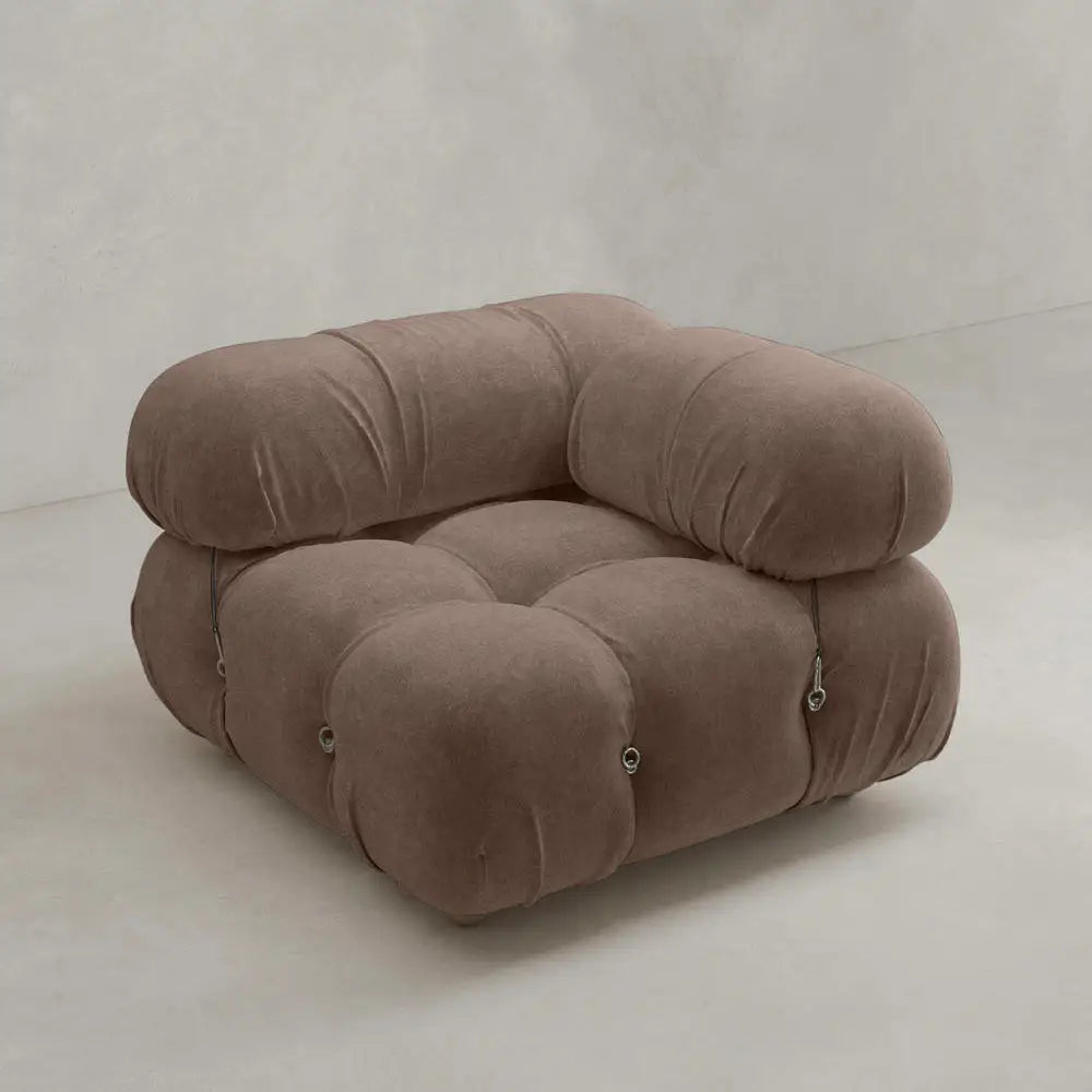 A plush, modern Belmont Sofa Left Armrest with marshmallow curves and rounded, tufted cushions in soft brown upholstery, featuring metal side fasteners, set against a plain, light background.