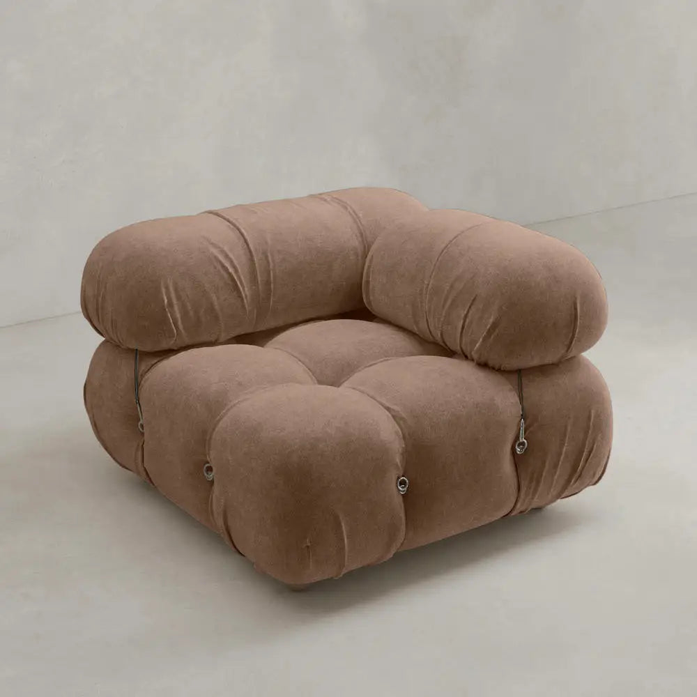 The Belmont Sofa Left Armrest features plush, marshmallow-like curves, rounded tufted cushions in soft brown fabric, a low wide seat, and metal button accents—an iconic classic set against a plain light background.