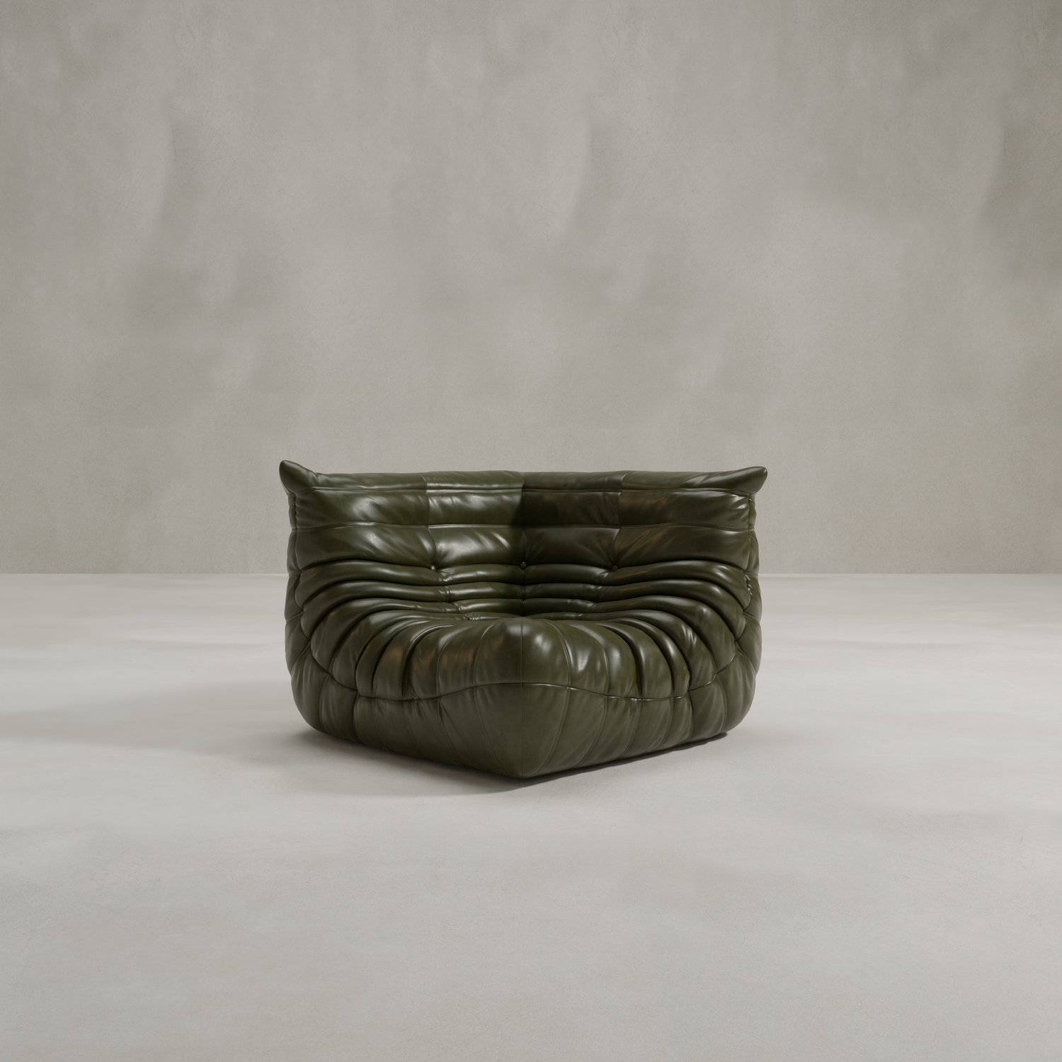 The Rolo Lounge Corner Sofa, a dark green modern armless piece with soft gathered leather upholstery and mid-century inspiration, sits on a light textured floor against a plain light gray wall.