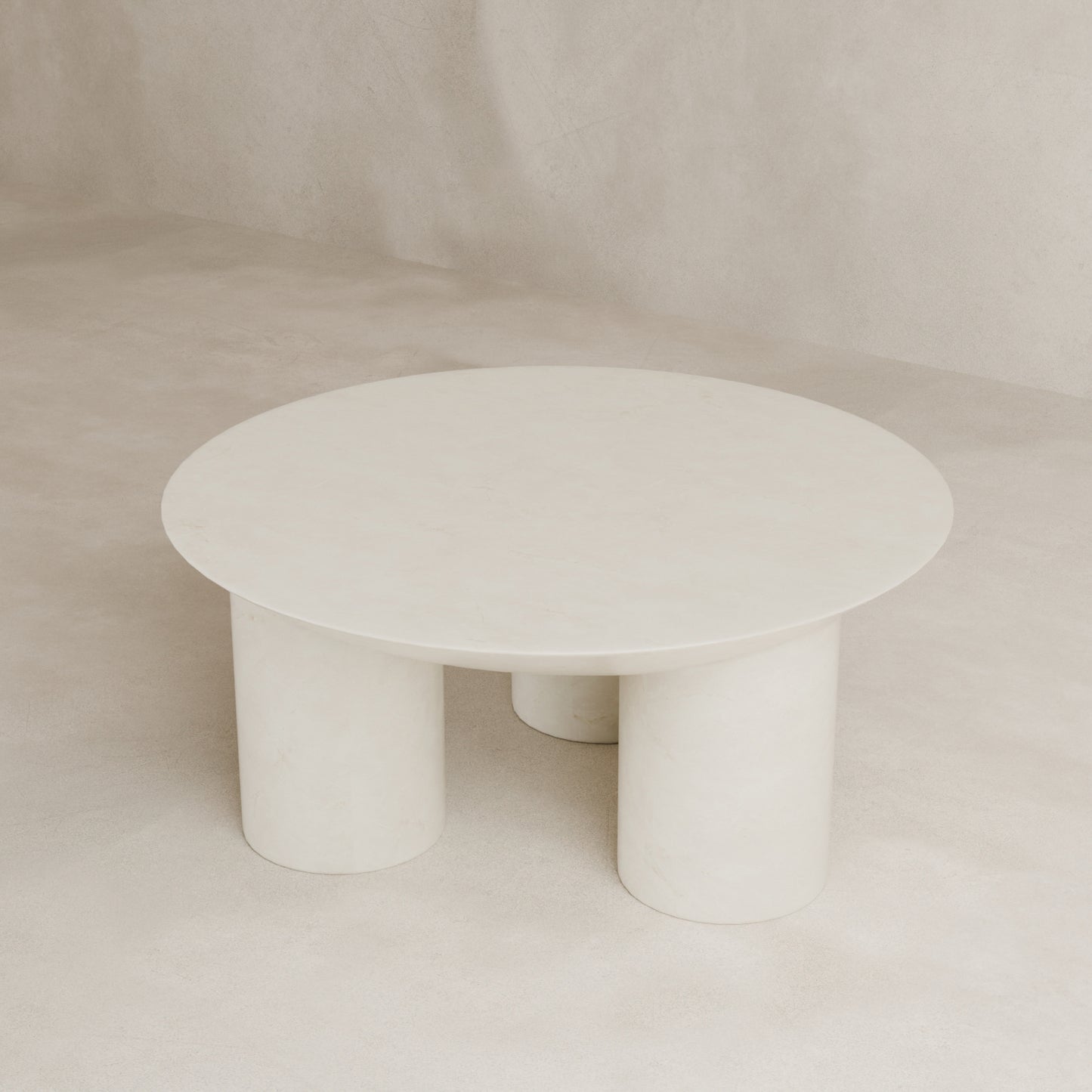The Luna Coffee Table, featuring a minimalist round fiberglass top and three tubular legs, is showcased against a light beige textured background, radiating modern elegance.