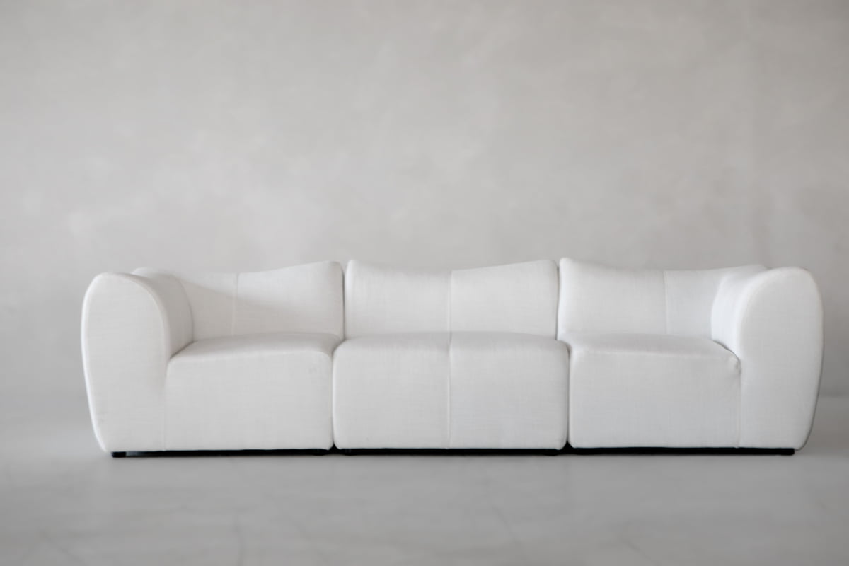 The Bambon 3 Piece Sofa Set features a modern, minimalist design with three white seats and low, rounded arms, perfectly capturing contemporary style against a plain light gray background.