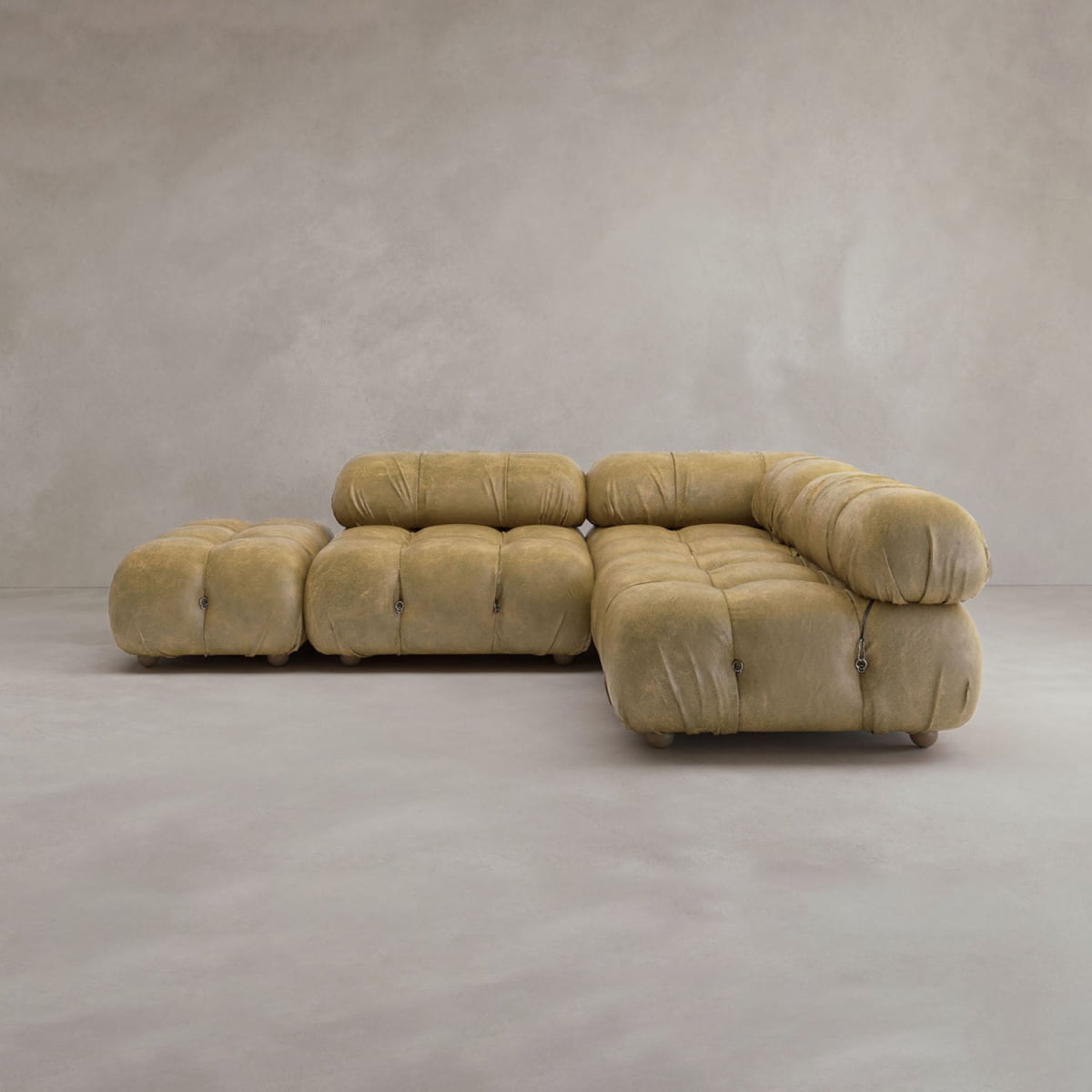 The Belmont Sofa Combination B, a modern modular cloud sofa with plush tufted cushions, forms an L-shape on a smooth light gray floor against a plain gray wall.