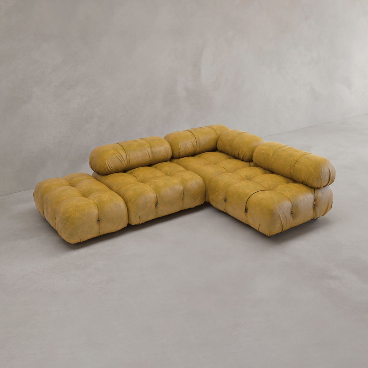 The Belmont Sofa Combination B features modern, tufted mustard yellow upholstery, creating an iconic classic look on a light gray floor against a plain, light-colored wall.