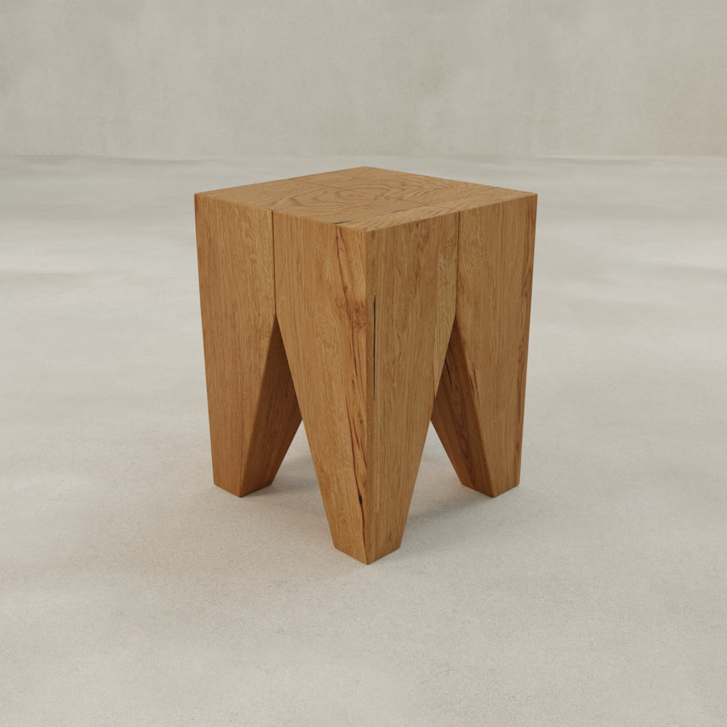 The Branston Stool features a solid wood square seat and four wide, angled legs, shown on a light-colored surface with a neutral background.