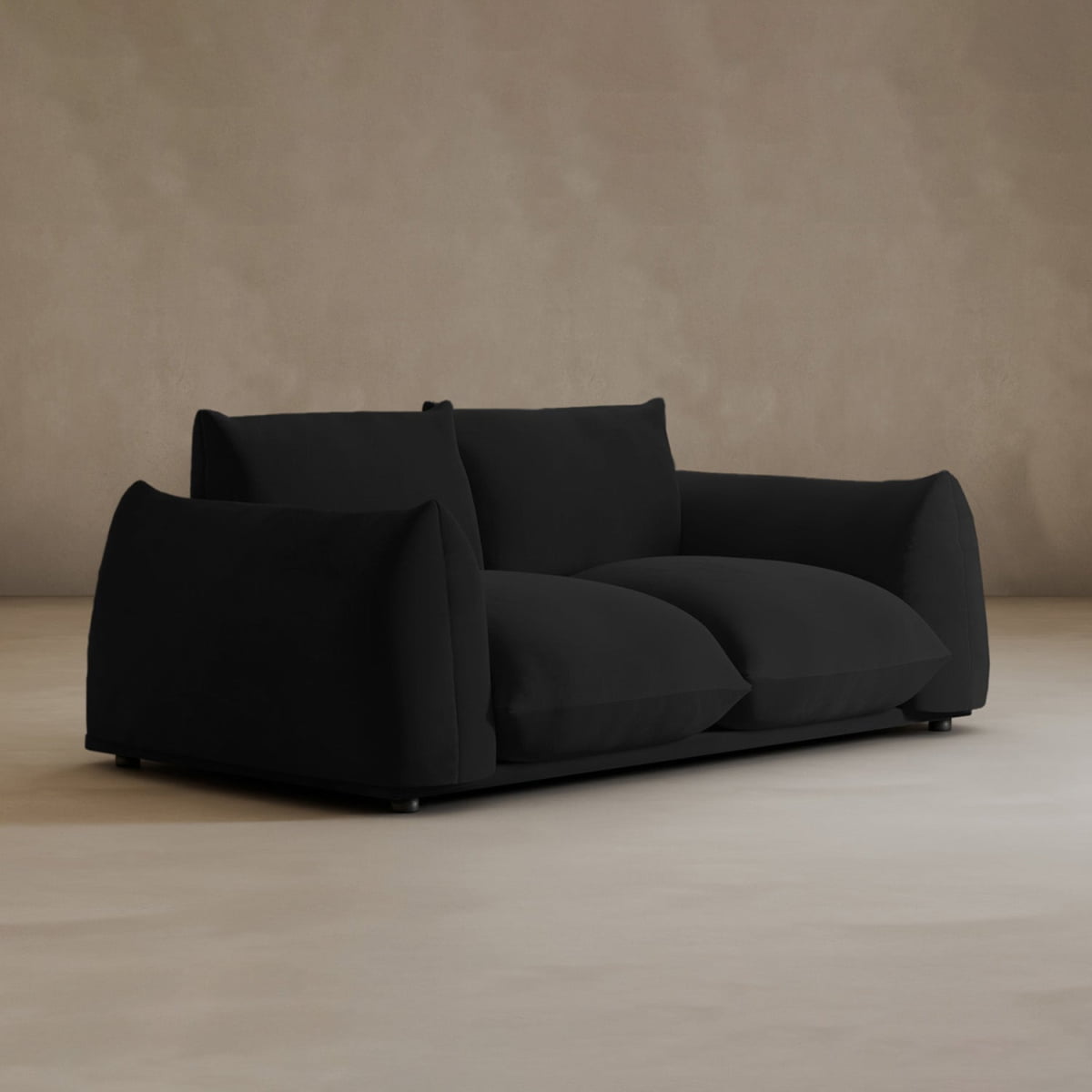 The Calypso Loveseat is a modern black 2-seater with deep cushioned seats and plush armrests, exuding elegance against a plain beige background.