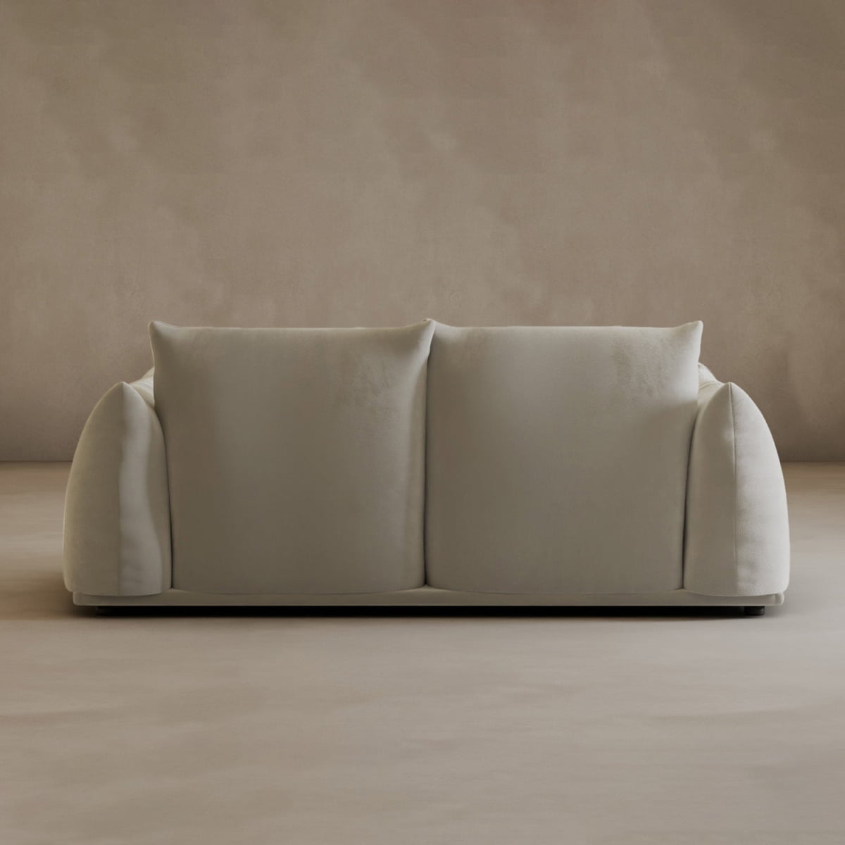 The Calypso Loveseat features a minimalist beige design with soft, rounded arms and two large back cushions, adding modern elegance to any simple interior when paired with matching beige walls and floors.