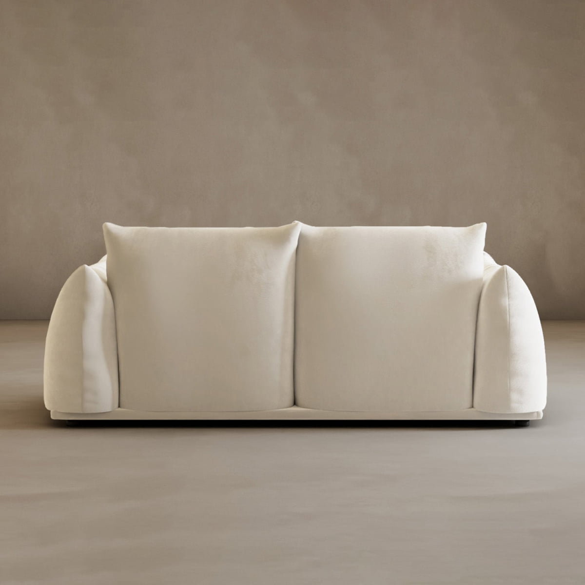 The Calypso Loveseat, a cream 2-seater with soft, rounded arms and two large back cushions, brings modern elegance to any space against a neutral taupe wall and floor.