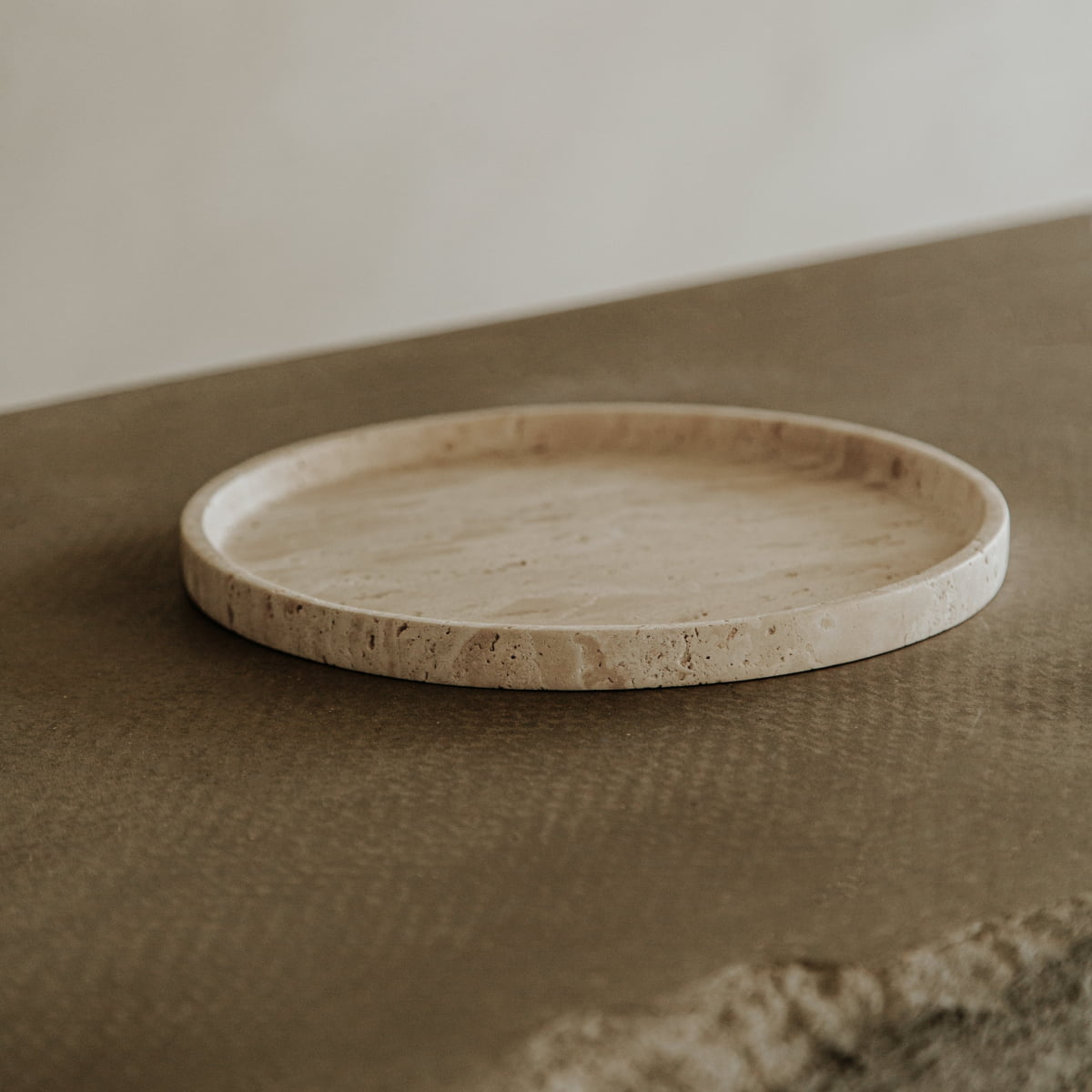 The Cascade Tray in Large showcases its natural elegance as it rests on a textured brown surface, set against a softly blurred neutral background.