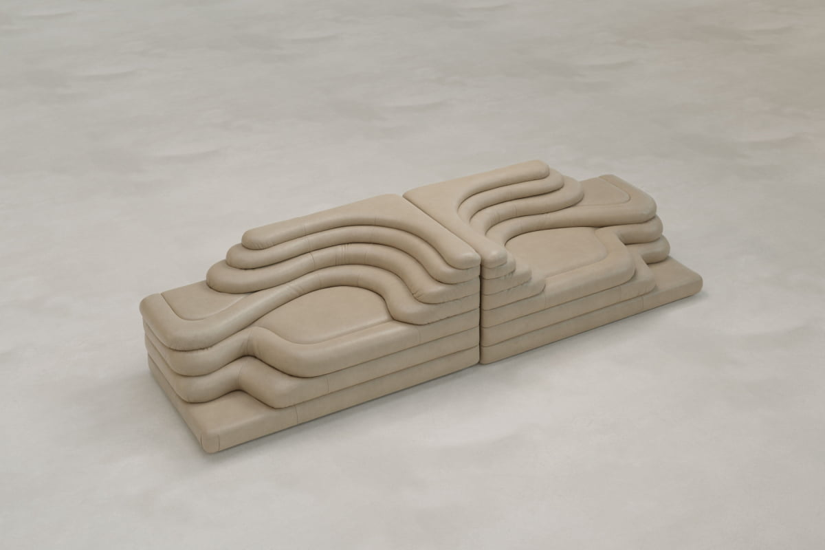 The Cascata 2 Piece Sofa features modern beige modular design with layered, wave-like cushions for an iconic, sculptural look and a luxurious statement on any light, textured floor.