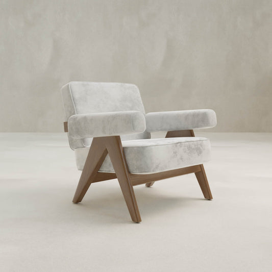 The Chelsea Lounge Chair offers a mid-century look with light gray faux mohair upholstery and angular wooden legs, adding stylish comfort to this minimal, neutral-toned space.