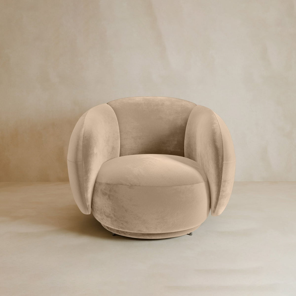The Clara Armchair features plush velvet upholstery, soft curved armrests, and a cushioned seat, adding contemporary style to any beige setting.