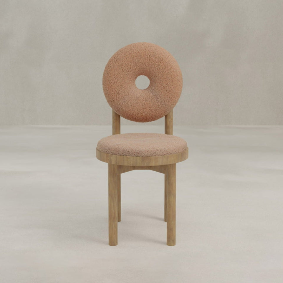 The Donut Chair features a contemporary design with a signature center-hole seat-back, round cushioned seat, and wooden legs—a standout piece for any modern space.