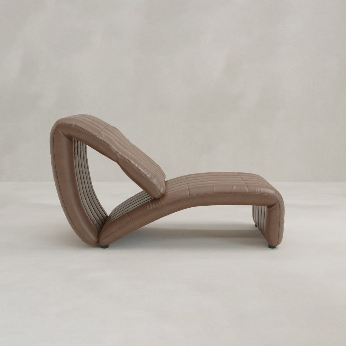 A modern Hillier Chair in brown, S-shaped design with horizontal stitching and premium vintage leather, shown on a plain light background.
