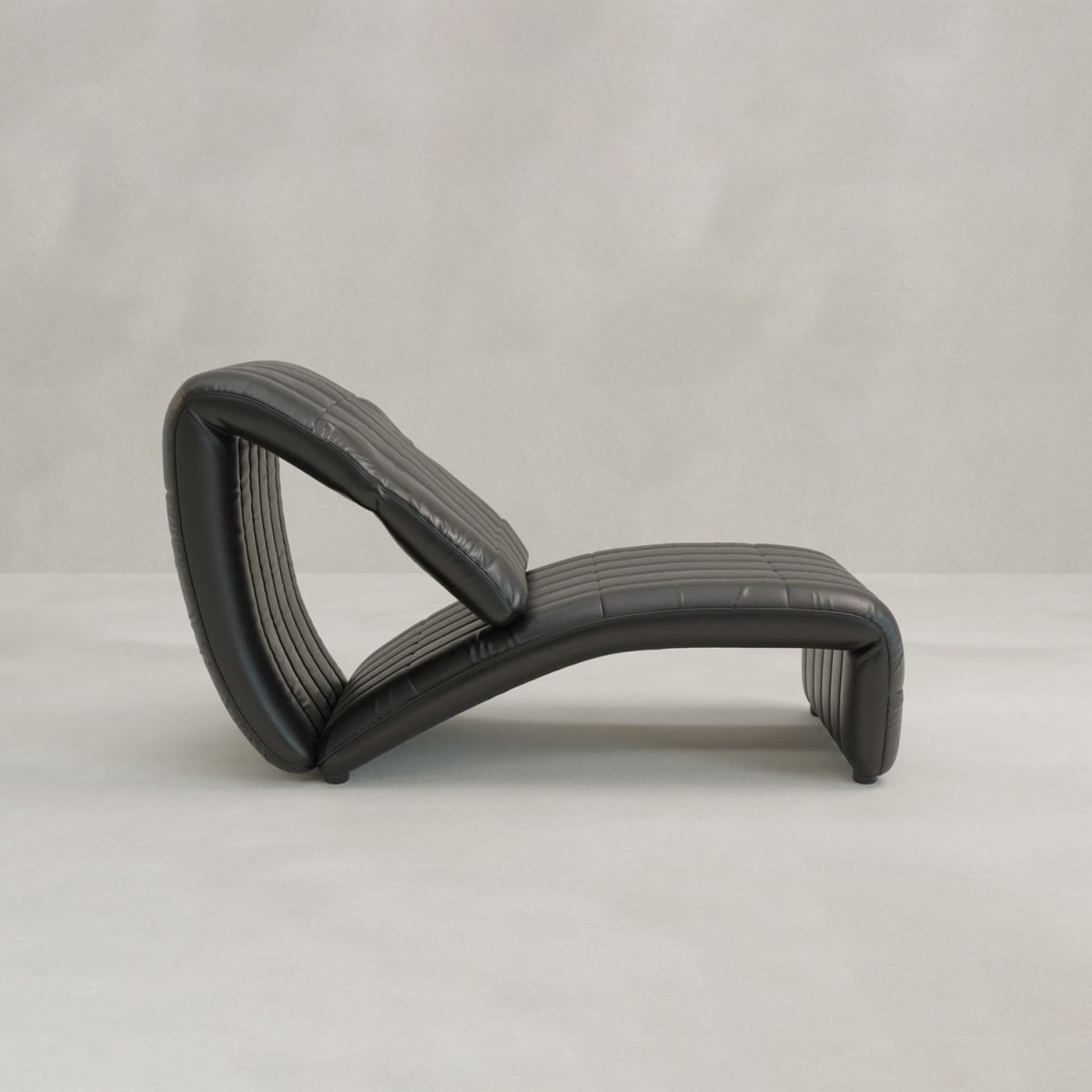 The Hillier Chair, crafted in premium vintage leather with sculptural, curved lines and reclining features, is showcased on a light gray floor against a plain light gray background.