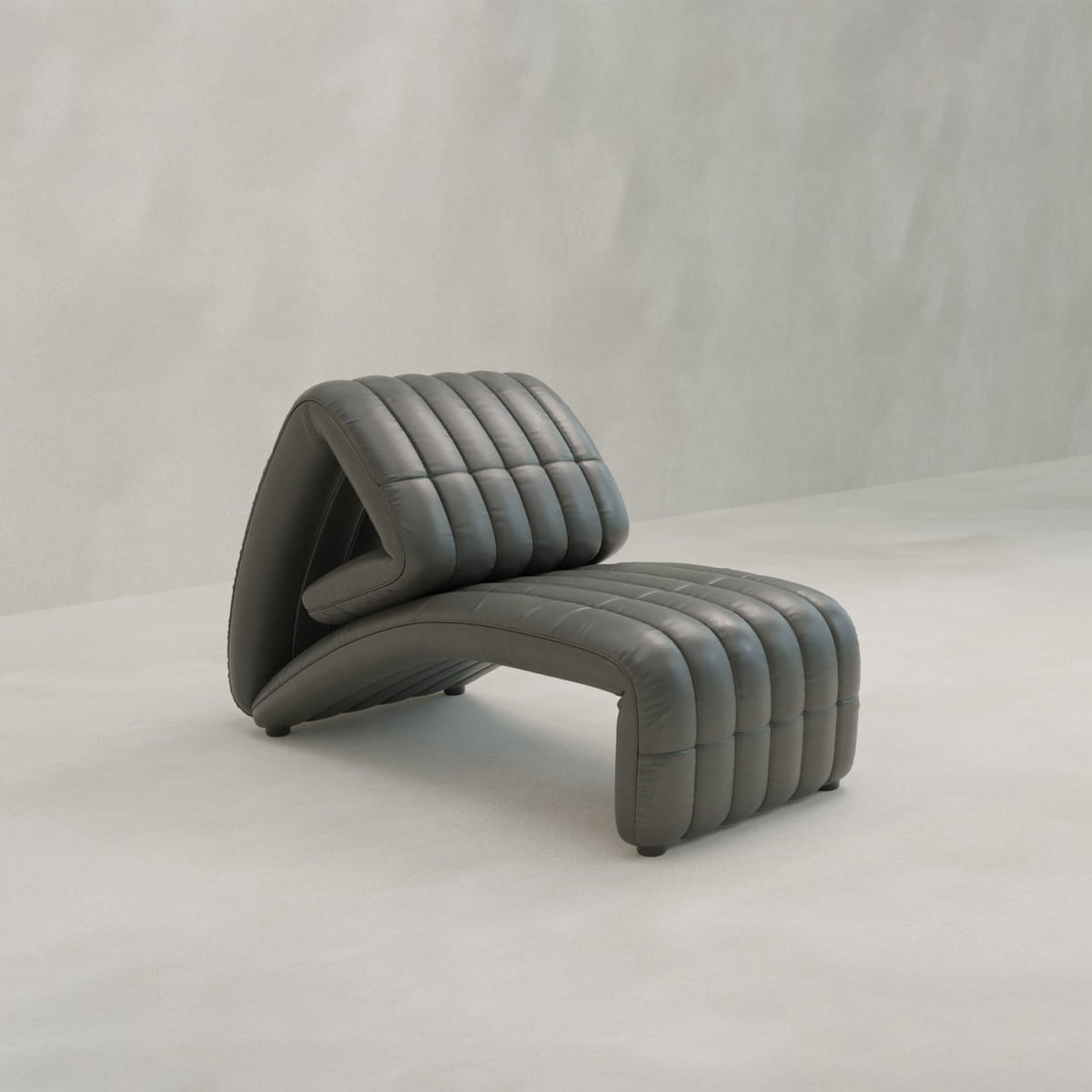 The Hillier Chair features a modern, angular zigzag design with a dark gray ribbed and cushioned surface in premium vintage leather, set against a light, minimalist background.