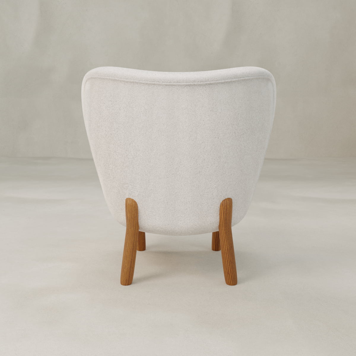 The Hornsey Chair is a modern, compact accent chair with white fabric upholstery, seen from the back. It features gently curved lines and four angled wooden legs, set against a neutral, light-colored background.