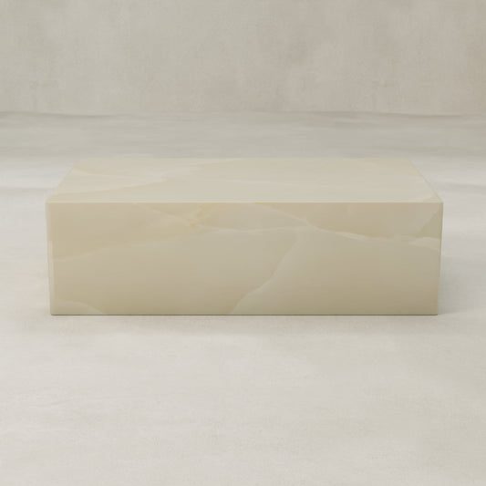 The Lunelle Onyx Coffee Table features a rectangular, smooth surface with a milky hue and subtle golden veining, shown against a neutral light background.