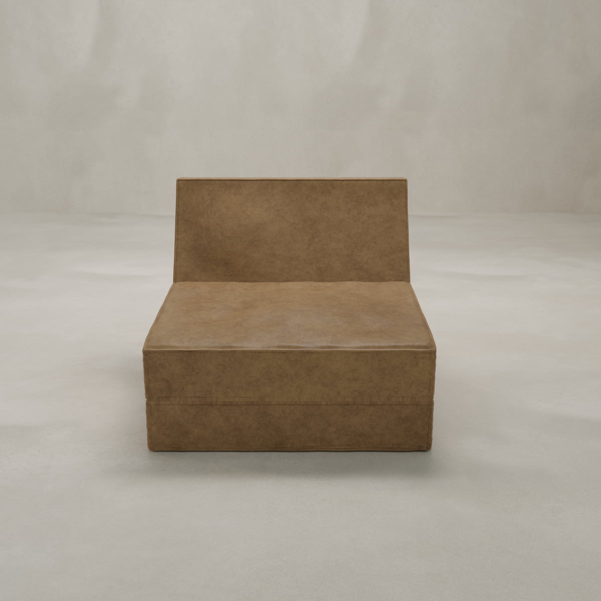 The Meazza Lounge Chair, featuring a modern minimalist design with a low backrest and boxy silhouette, stands in an empty room with light walls and floor, bringing contemporary sophistication to any interior.