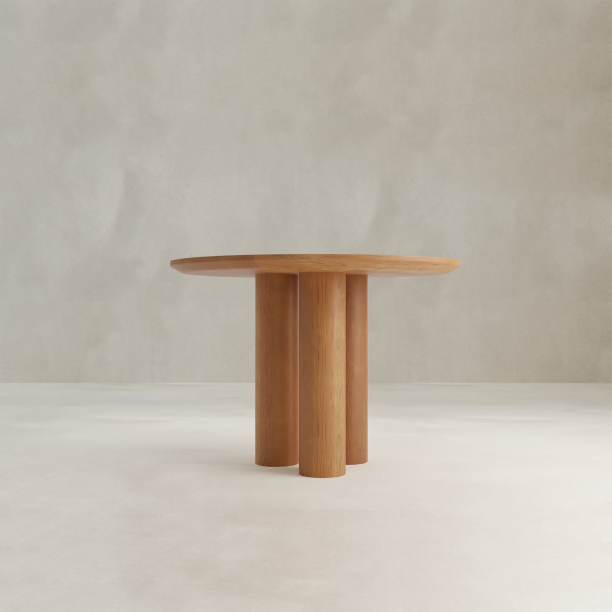The Milo Large Wood Dining Table features a spacious round wooden top and three thick cylindrical legs for a modern look, ideal for compact spaces, shown against a simple light background.