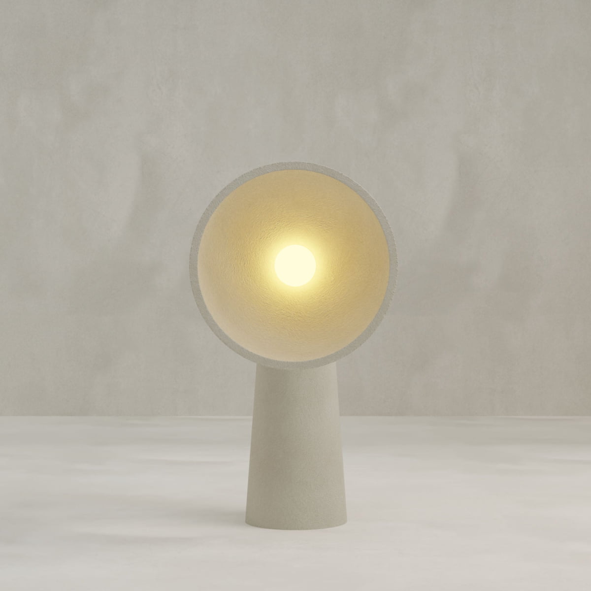 The Orbis Medium Floor Lamp features a wide, circular shade and a cylindrical base, blending sculptural artistry with modern minimalism while glowing softly against a light gray background.