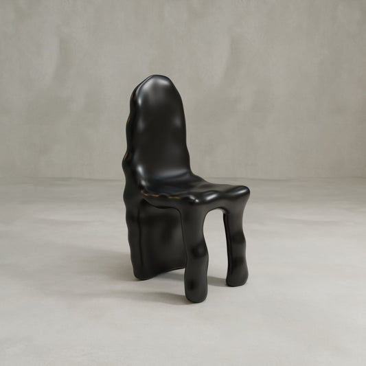The Phantom Chair, a modern design in glossy black with an organic shape and sculptural wavy legs, stands on a light floor against a beige backdrop—a bold nod to brutalism and contemporary craftsmanship.