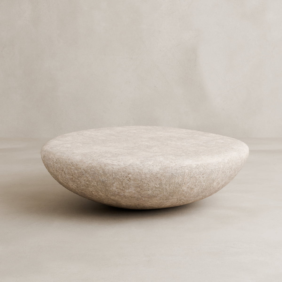 The Pluto Coffee Table features a smooth, round white design with a beige, textured surface, set against a matching minimalist background—an ideal chic centerpiece for modern interiors.