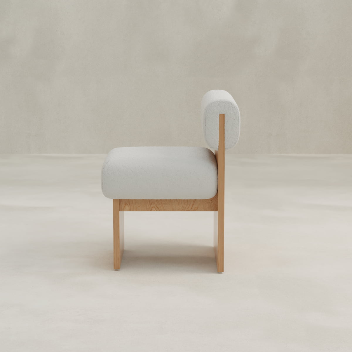 The Primrose Chair features a minimalist design with a light wooden frame and white bouclé fabric upholstery on the seat and backrest, displayed from the side against a plain, light-colored background.