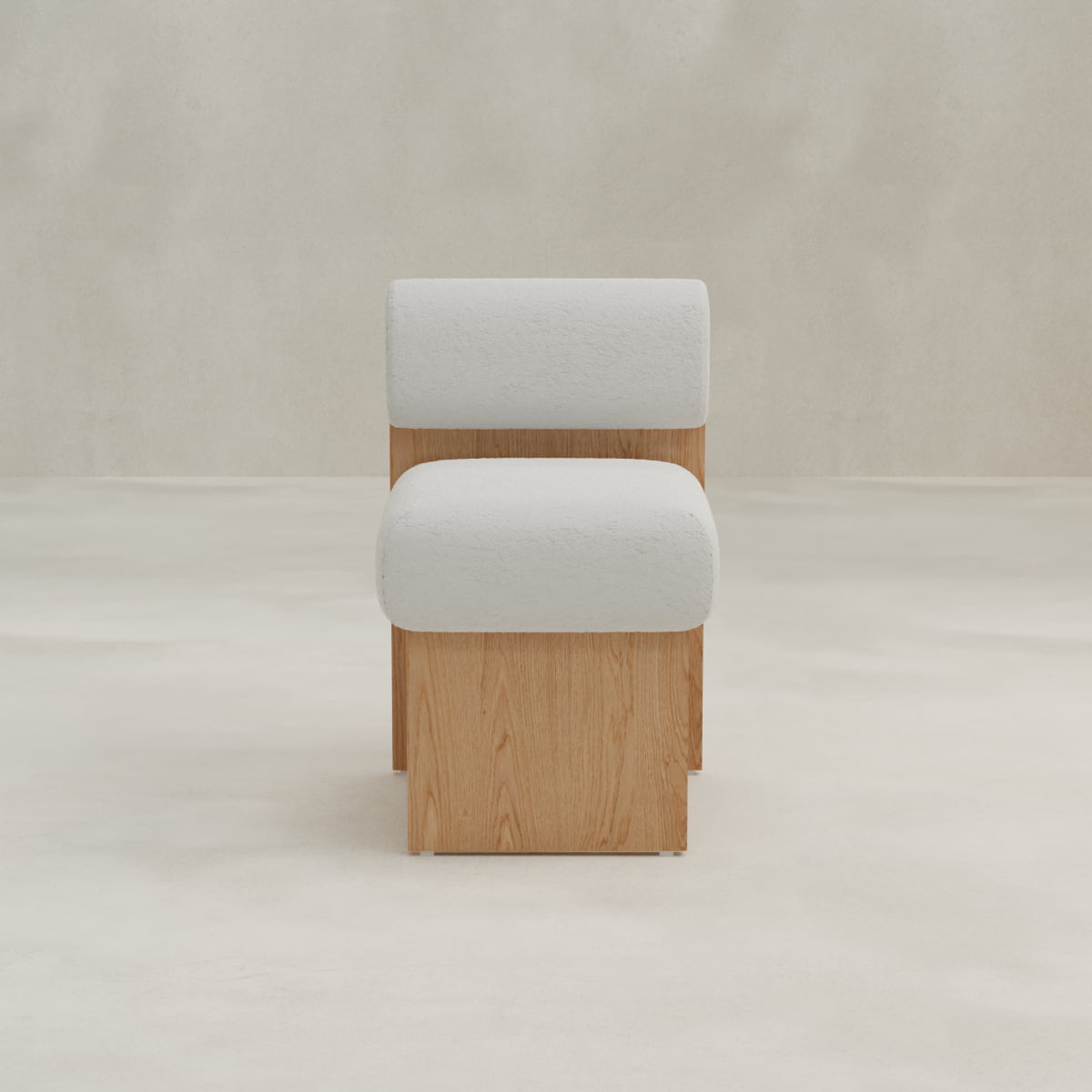 The Primrose Chair features a light wooden base and a white bouclé fabric padded seat and backrest, displayed in a neutral, minimalist setting.