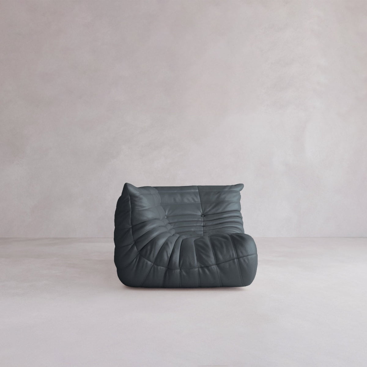 The Rolo Lounge Corner Sofa features soft, tufted black leather upholstery and a modern, low-profile design inspired by mid-century style, shown here on a light floor with a plain, pale wall backdrop.
