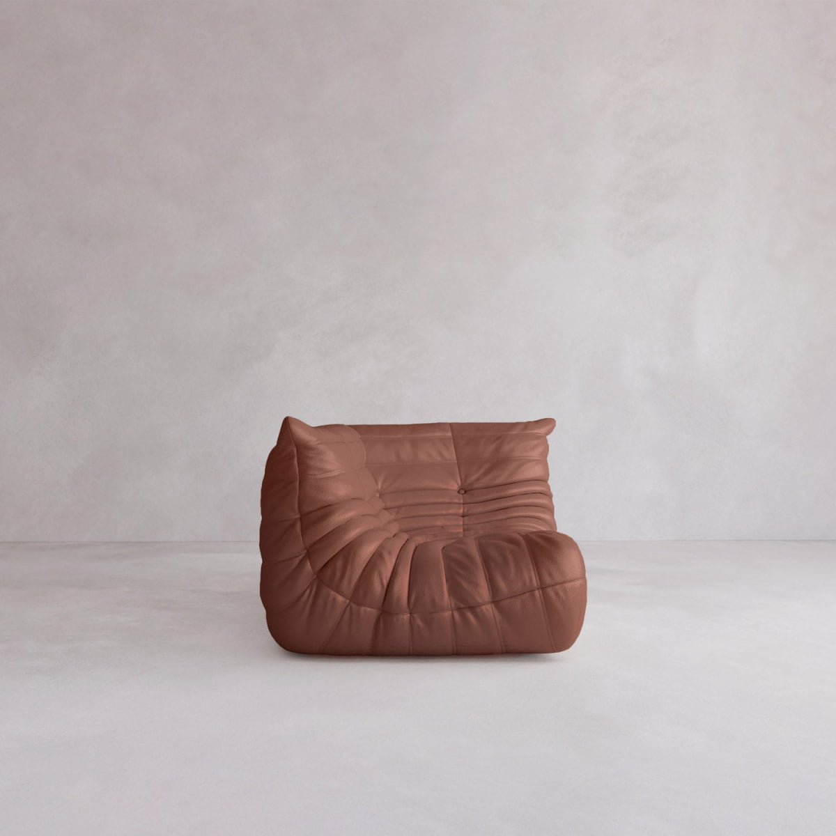 The Rolo Lounge Corner Sofa is a modern, armless brown leather piece with a tufted, curved design and mid-century influence, placed on a light grey floor against a plain pale background.