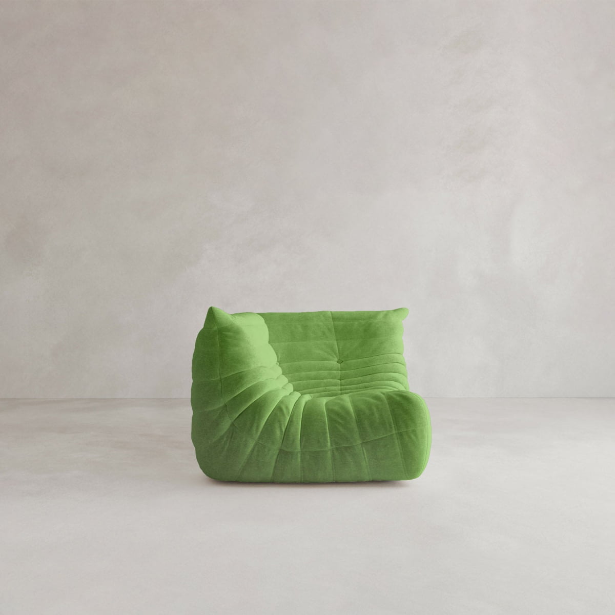 The Rolo Lounge Corner Sofa, a modern low-profile piece with plush ruched upholstery in bright green, is featured against a light plain background, evoking 70s-inspired style.