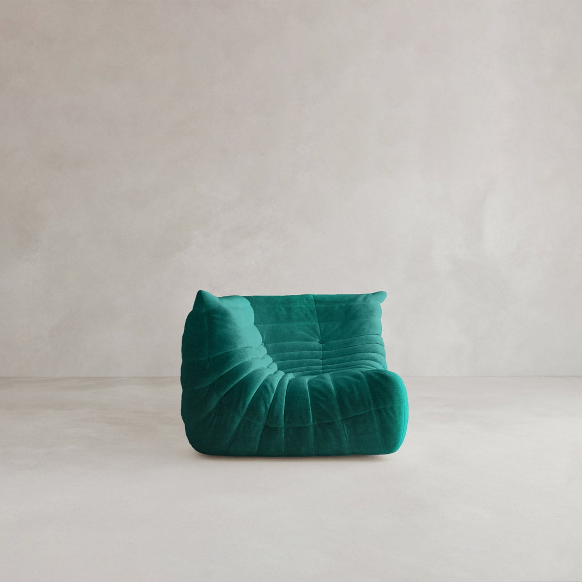 The Rolo Lounge Corner Sofa, with its 70s-inspired design and deep green, tufted upholstery, sits on a light neutral floor against a plain pale wall.