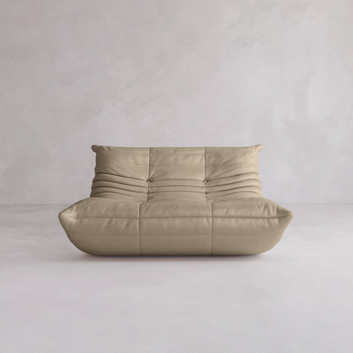 The Rolo Lounge Loveseat, a beige low-profile sofa with tufted cushions and subtle mid-century design, sits against a light neutral background.