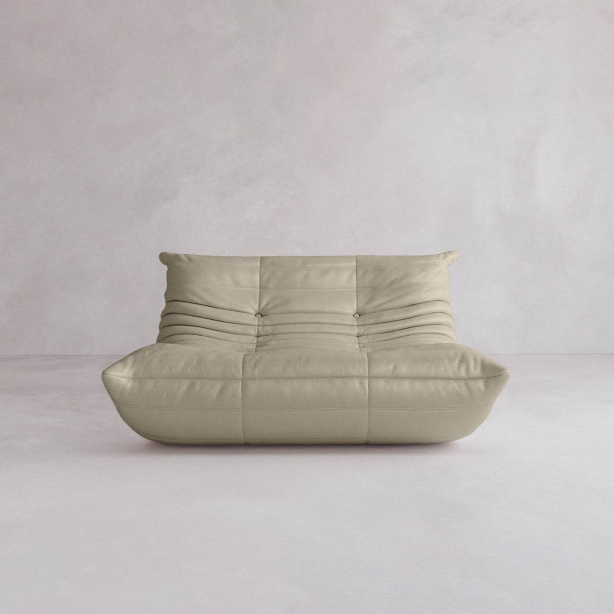 The Rolo Lounge Loveseat, featuring a beige, armless, plush tufted design inspired by mid-century style, sits against a light-colored, minimalist wall and floor background.