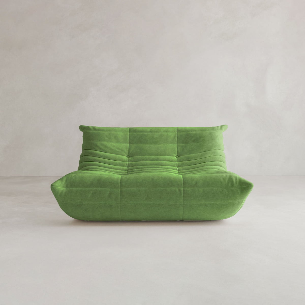 The Rolo Lounge Loveseat features modern green upholstery, a low backrest, deep seat, and plush contours with subtle mid-century style—perfect for standing out against light-colored walls and floors.