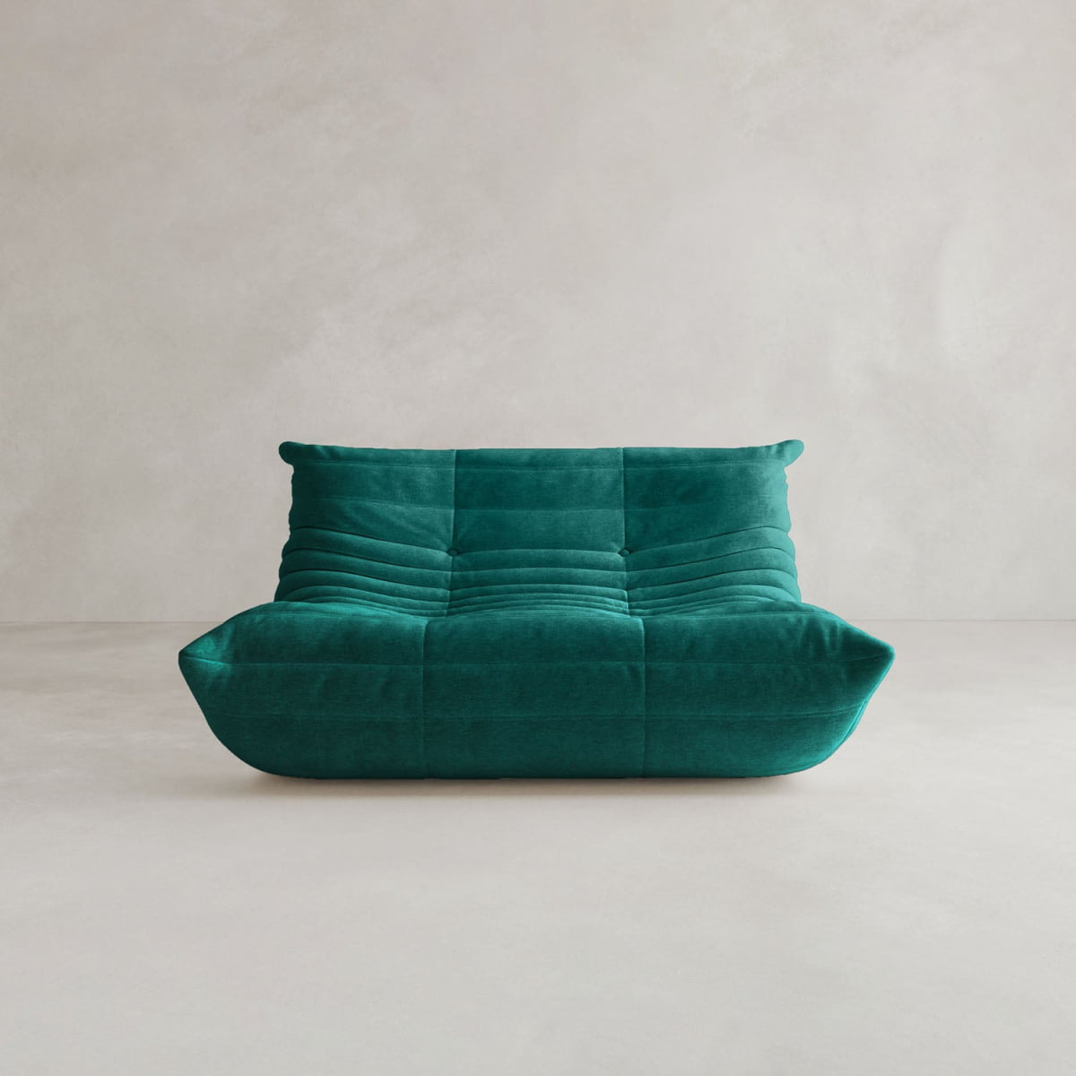The Rolo Lounge Loveseat features deep green upholstery, a low profile, plush armless seat, and a distinctive quilted tufted design inspired by mid-century style, set against a plain light-colored background.