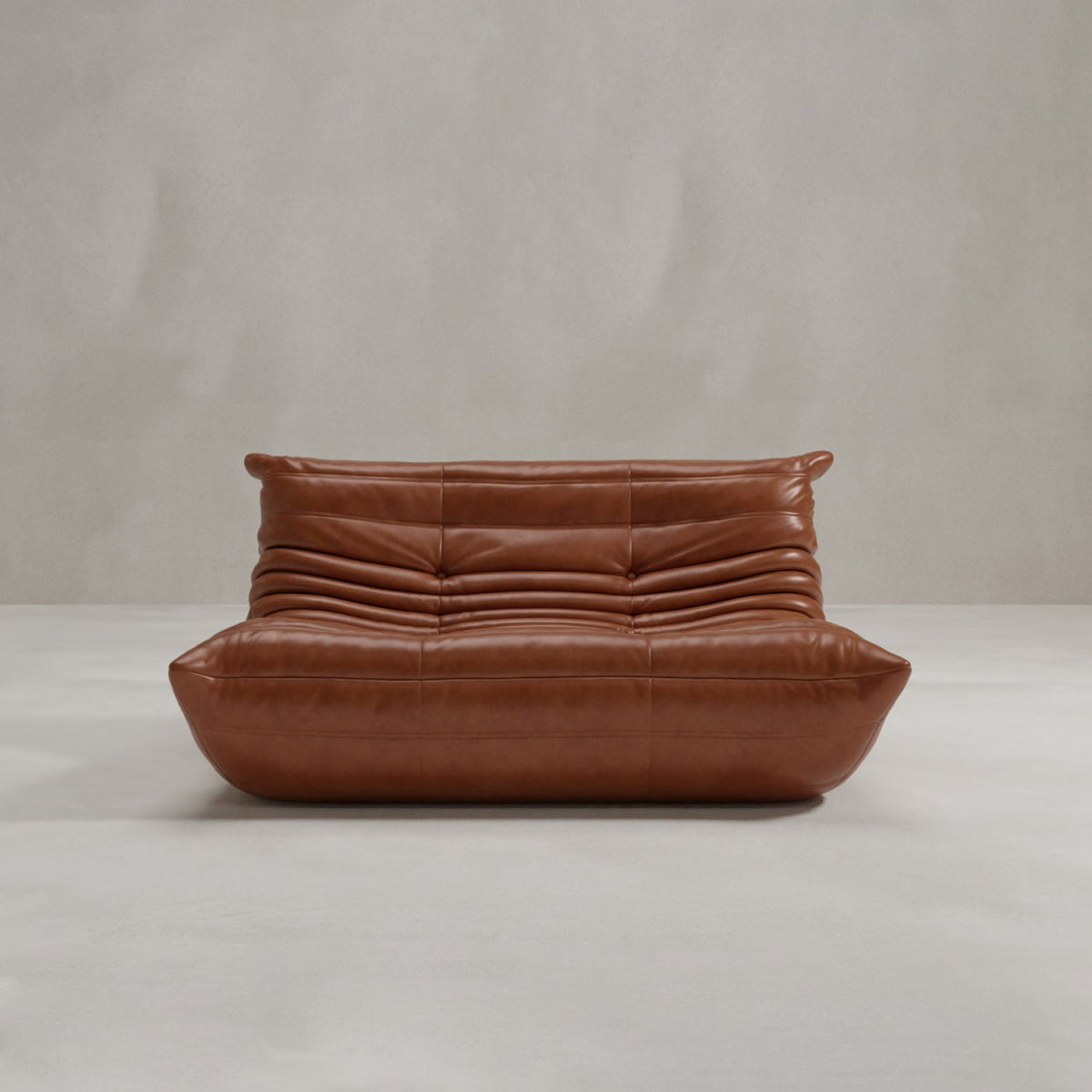 The Rolo Lounge Loveseat features a modern brown leather design with soft horizontal folds on the backrest and seat, low profile, and subtle mid-century influences, set against a light gray background.