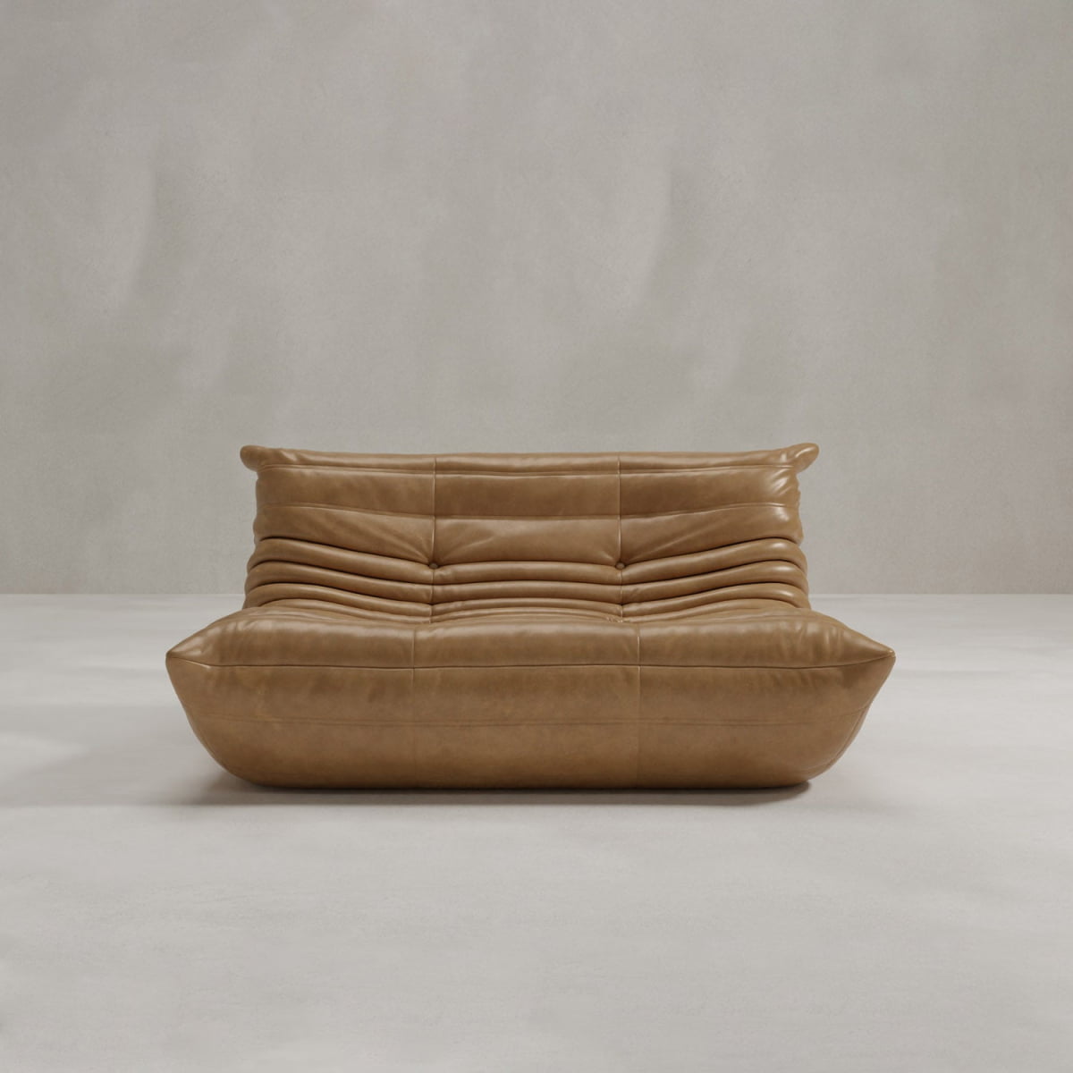 The Rolo Lounge Loveseat, featuring modern tan leather, plush horizontal tufting, and a sleek mid-century design, sits on a light floor against a neutral wall.
