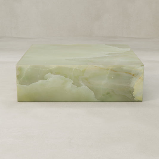 The Verdaine Onyx Coffee Table XL is a sculptural cube with a smooth, polished green onyx surface and natural veining set against a light beige background.