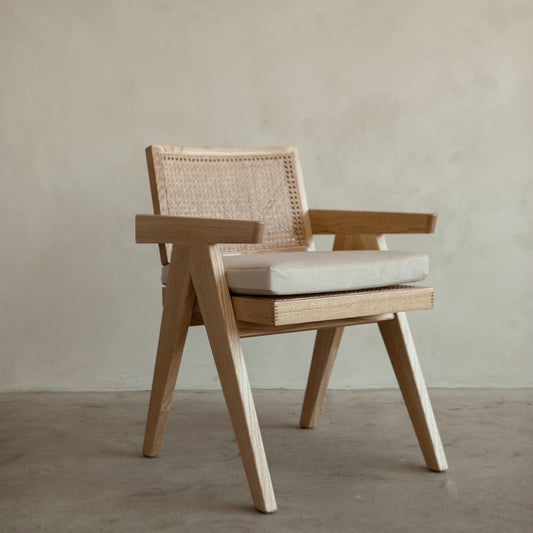 Light wood arm chair with cushion, hand-woven cane, sleek modern design